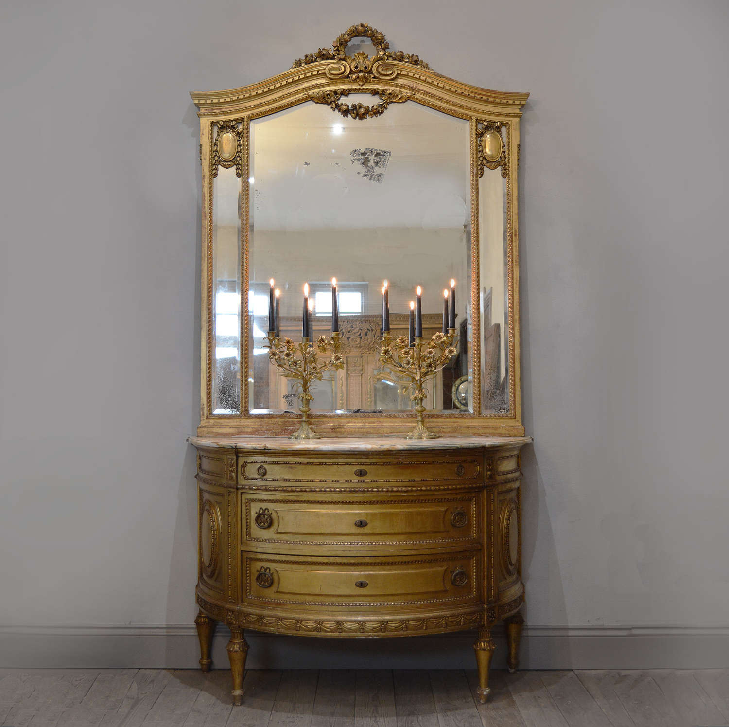 Grand scale giltwood demi-lune commode and mirror set by